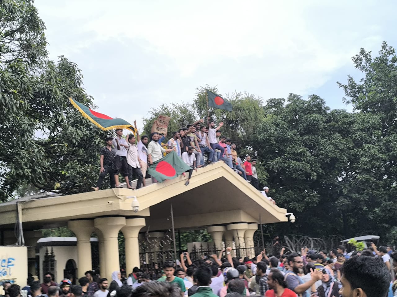 Students wave flags atop former prime minister Sheikh Hasina's official residence on August 5. Photo: Sajib Hasan