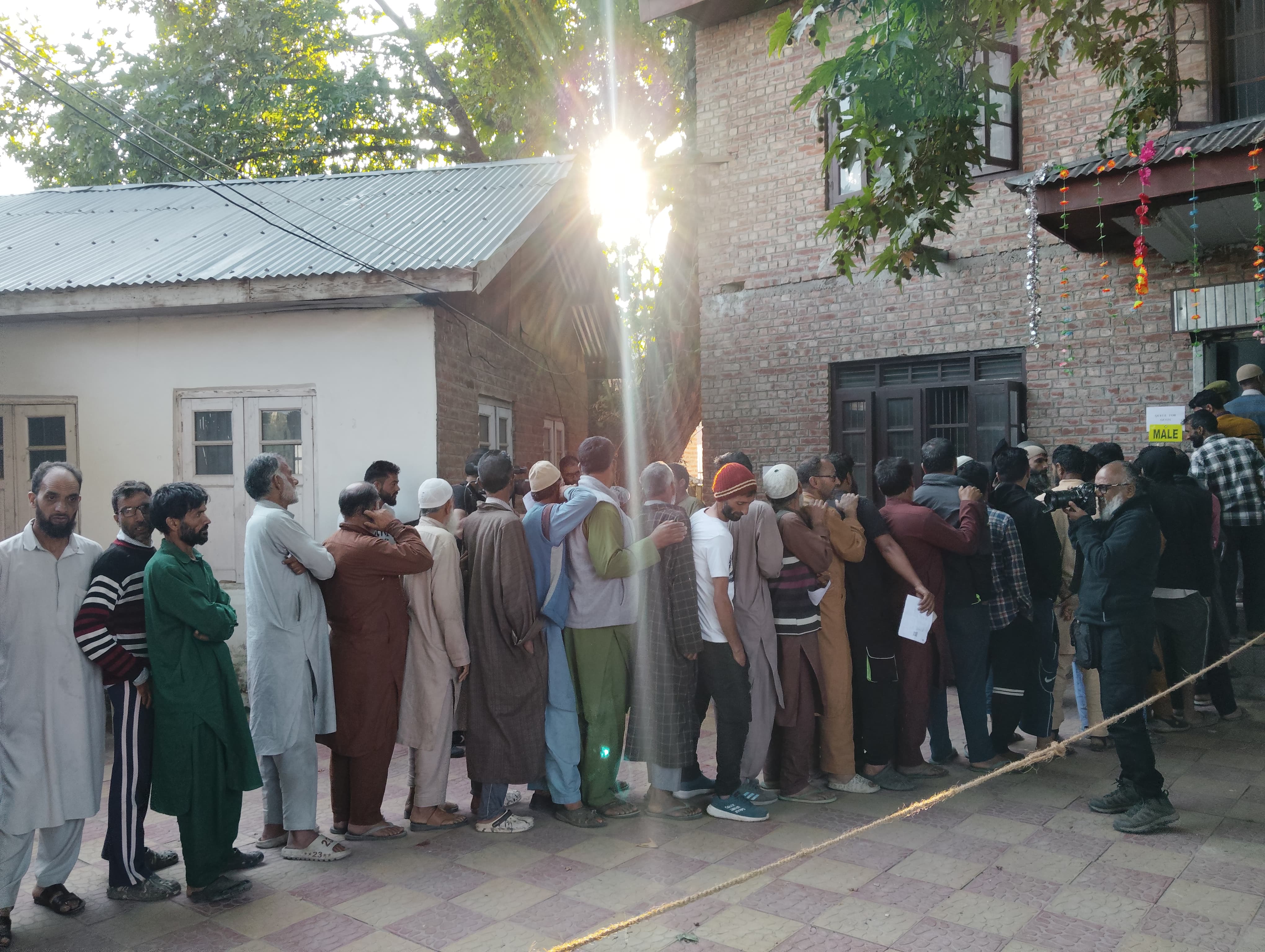 People line up at a voting booth in Pulwama district of Kashmir on September 19, 2024. Image Credit: Nasir Khuehami