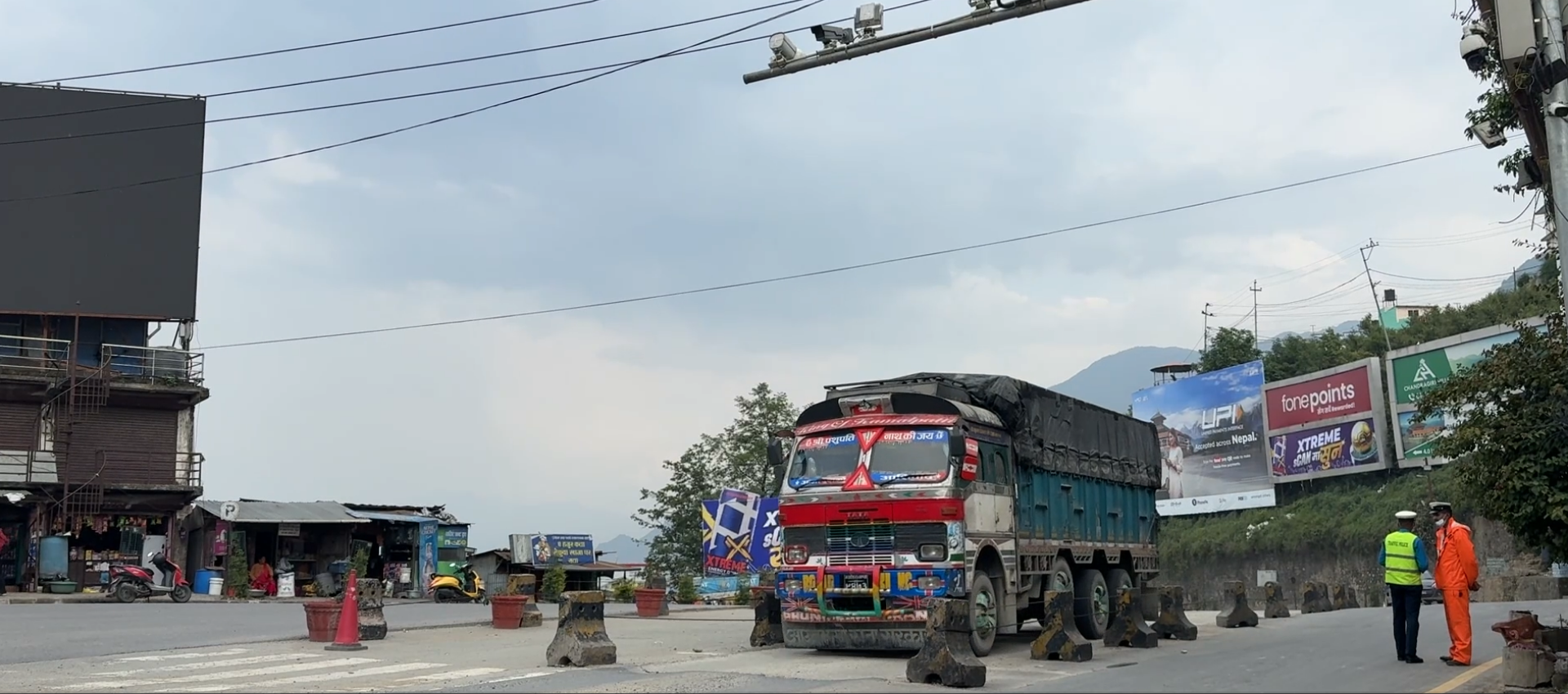 The photo shows a truck moving across a road, while security personnel could be seen on the right side of the frame.