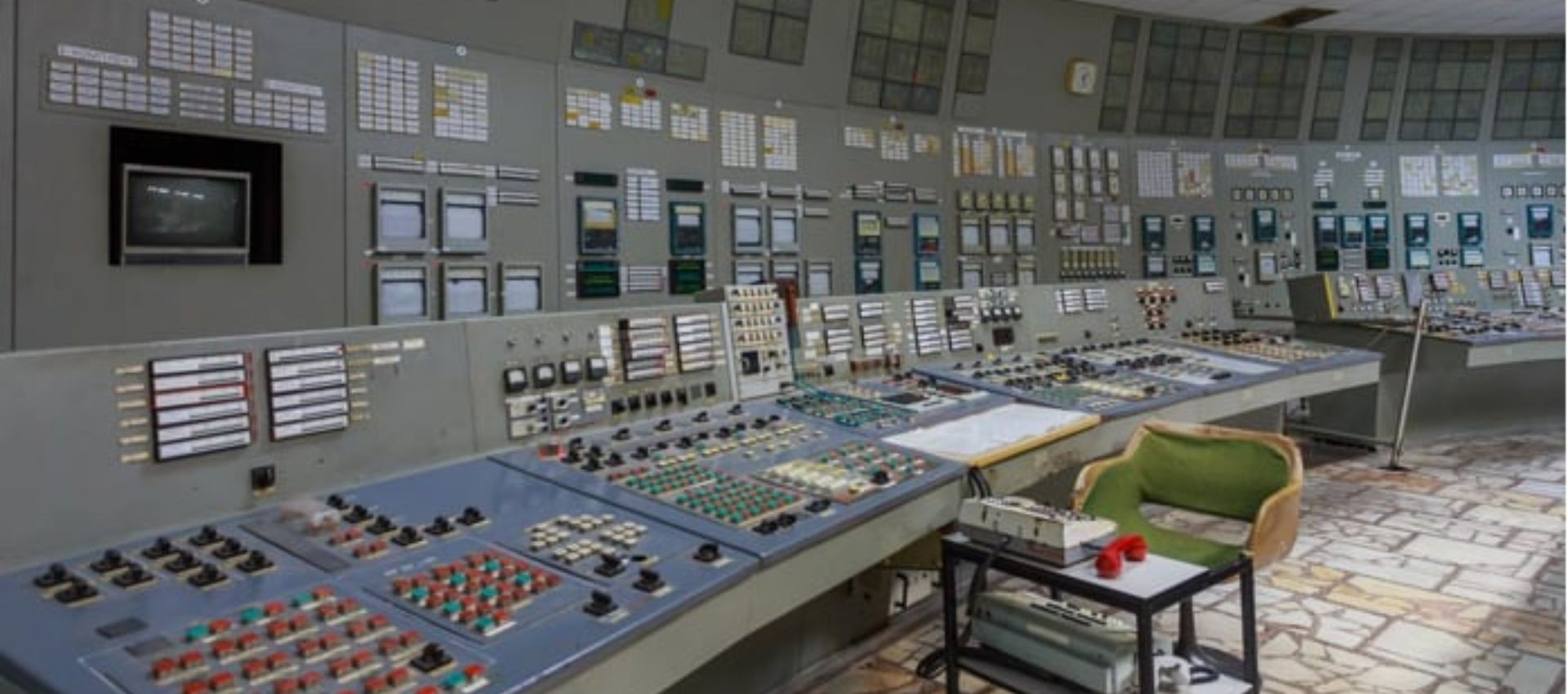A set of monitoring and control panels lined across the wall.