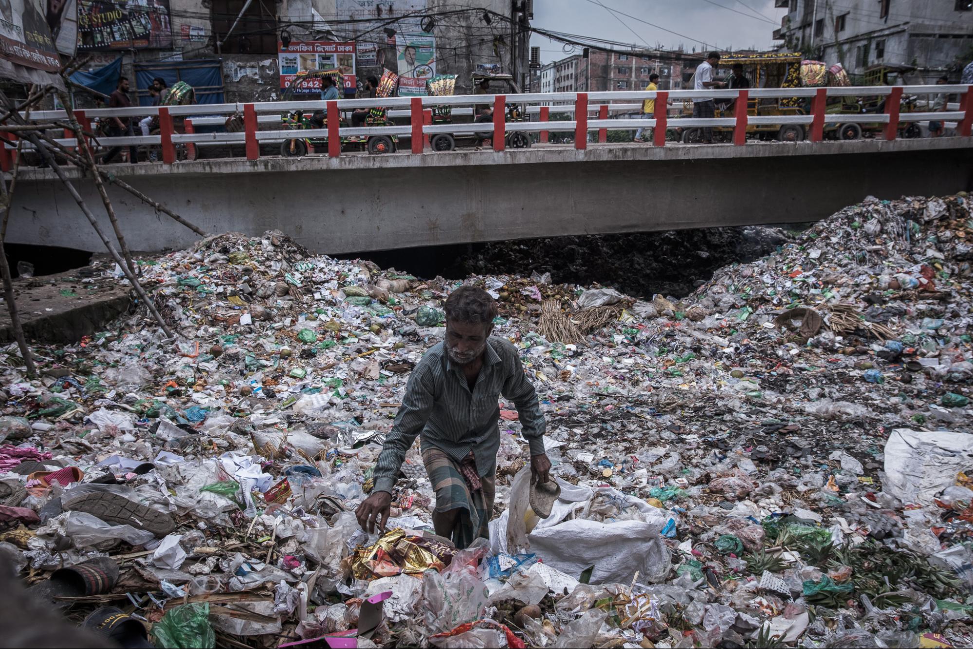 This is an image of a man collecting shoes in Southern Dhaka. 