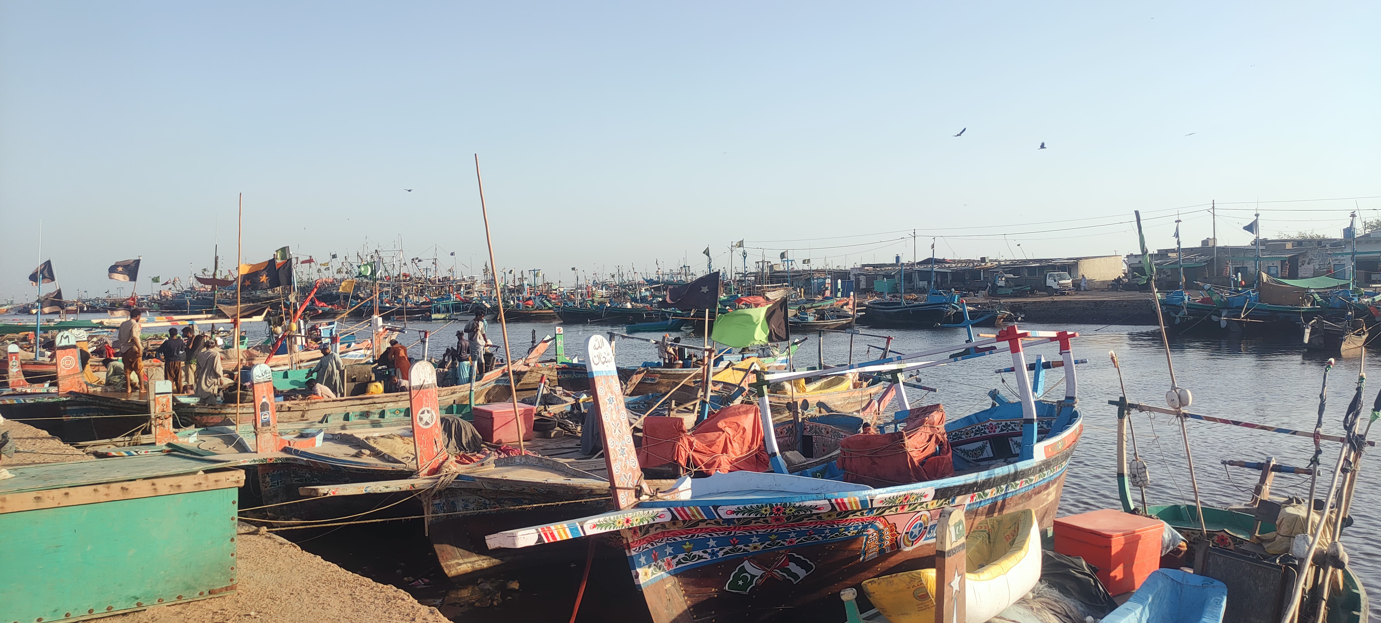 The image shows boats docked in Ibrahim Hyderi.